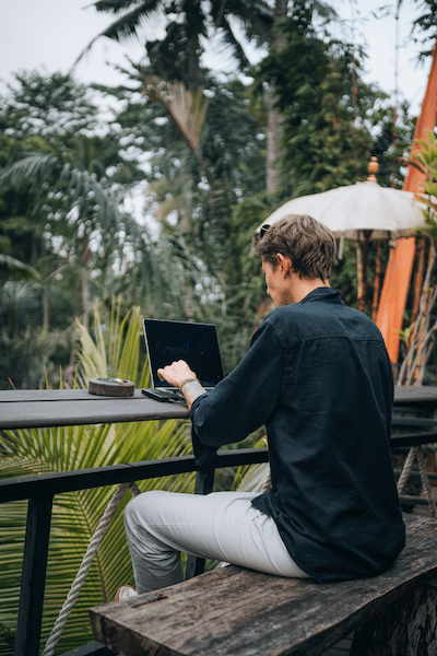 A man working remotely from Bali. With our ERP platform, you could manage your team from anywhere.